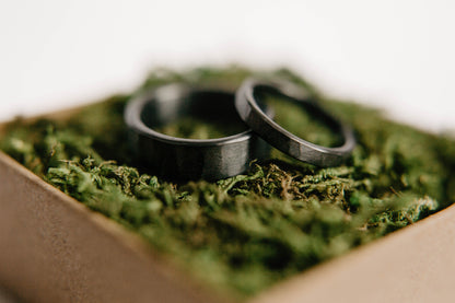 Black Zirconium Wedding Band Set. This photo shows two lightly faceted black zirconium rings. (Shown in ring box)