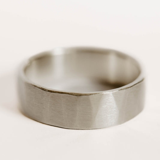 Mens sterling silver wedding band. This photo shows a lightly faceted silver ring (Horizontal with white backdrop)