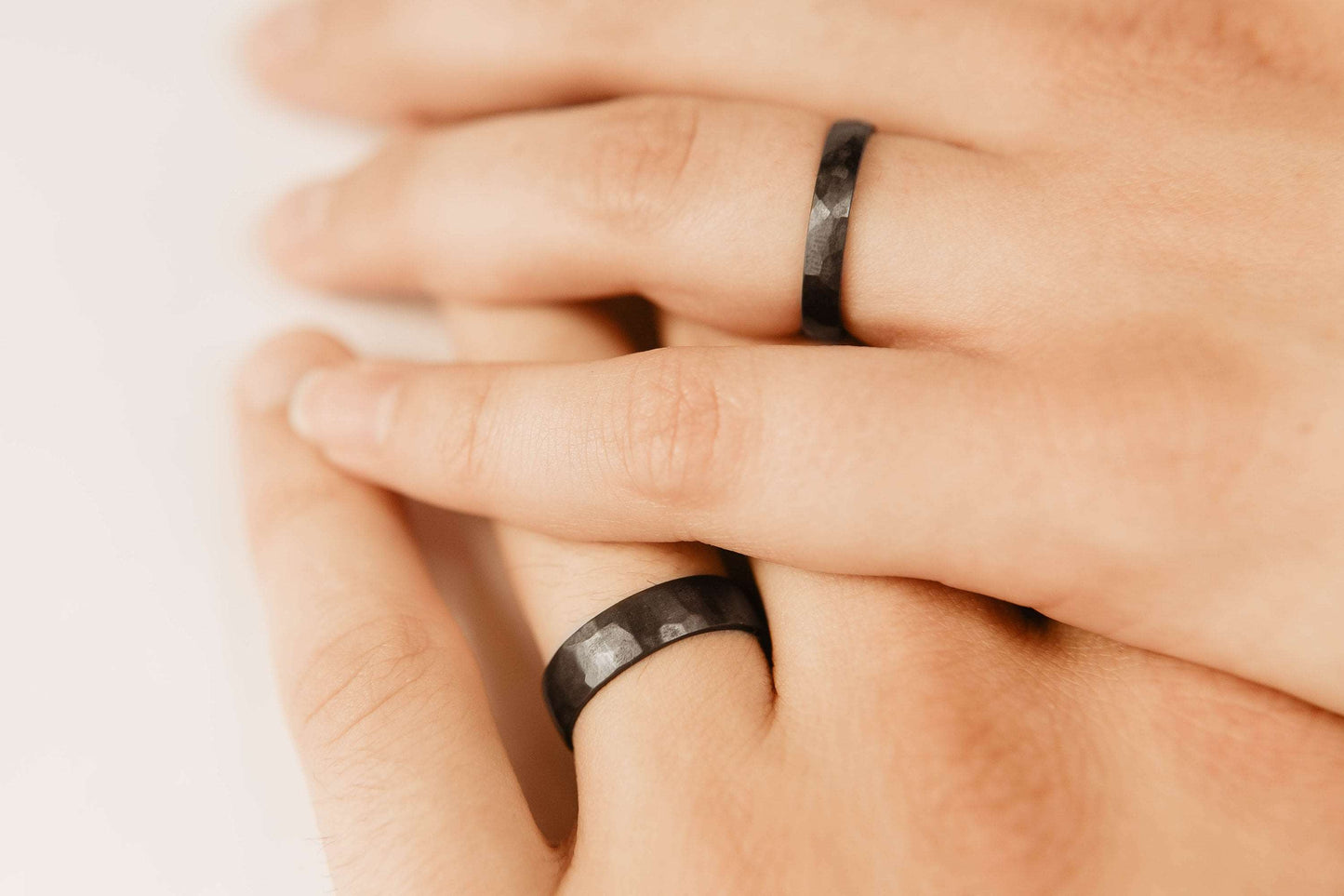 Black Zirconium Wedding Band Set. This photo shows two lightly faceted black zirconium rings. (Shown on hands)