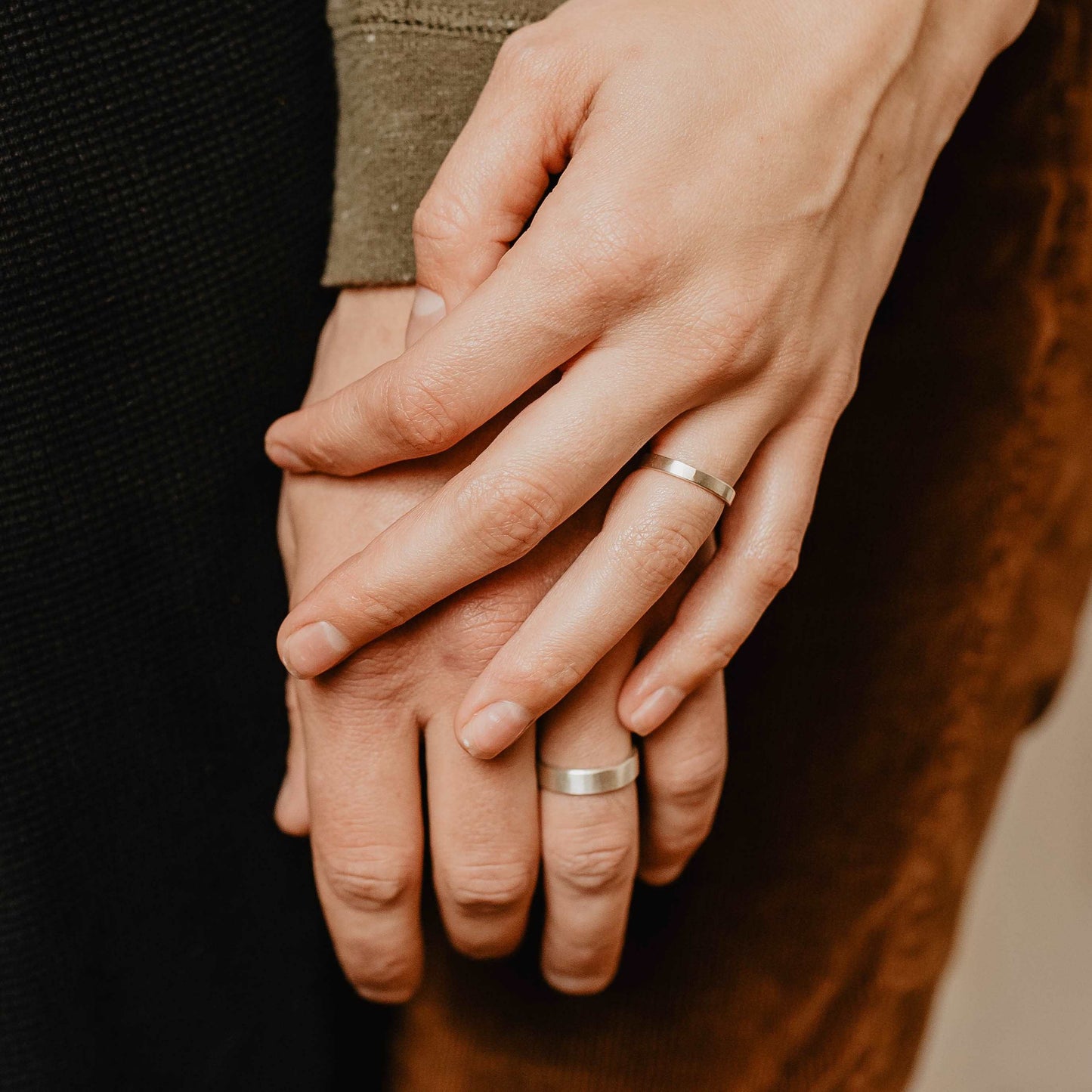 Handmade Silver Wedding Band Set. This photo shows two forged sterling silver rings. (Shown on fingers))