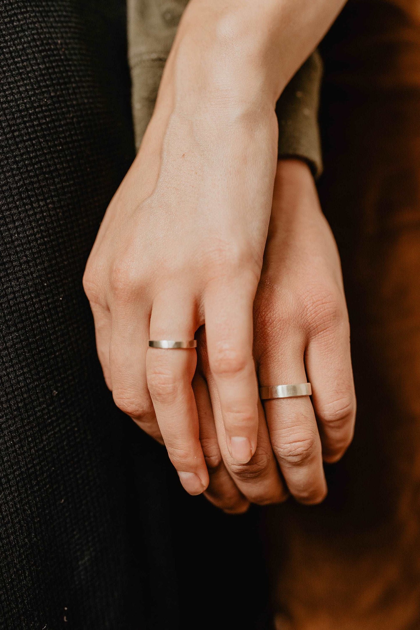 Handmade Silver Wedding Band Set. This photo shows two forged sterling silver rings. (Shown on fingers))