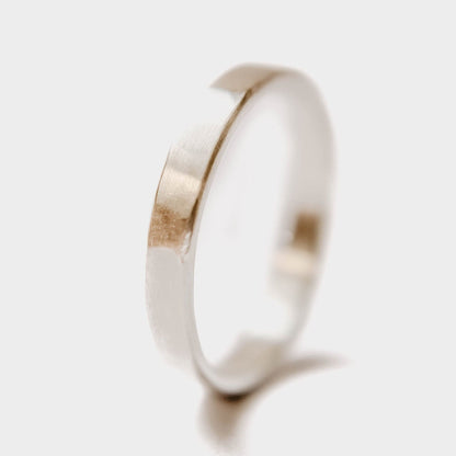 Womens sterling silver wedding band. This photo shows a lightly faceted silver ring. (vertical with white background)