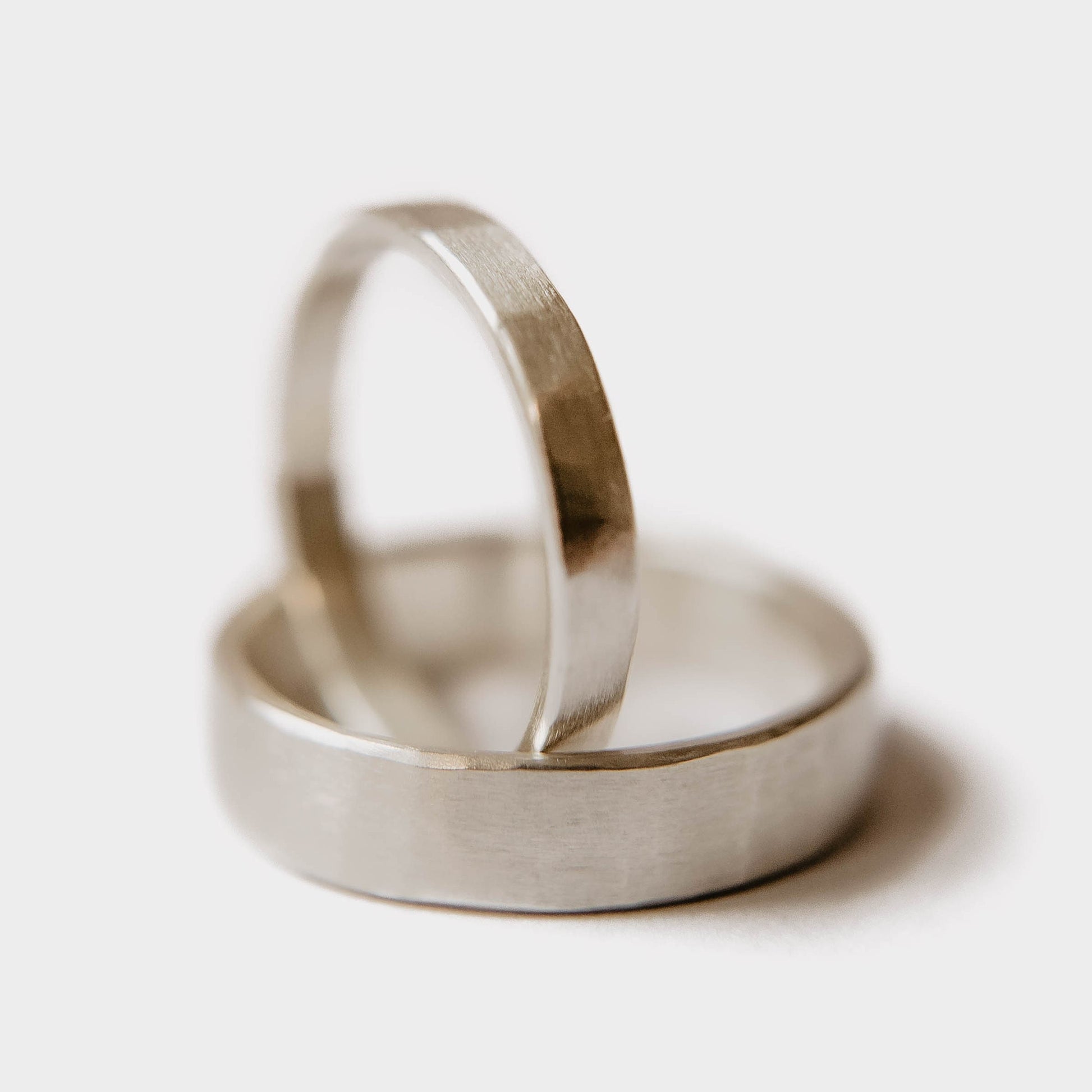 Womens sterling silver wedding band. This photo shows a lightly faceted silver ring. (vertical inside mens silver ring with white background)