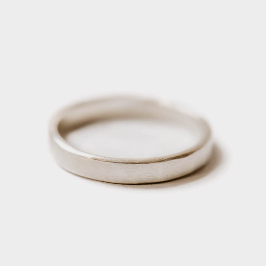 Womens sterling silver wedding band. This photo shows a lightly faceted silver ring. (horizontal with white background)