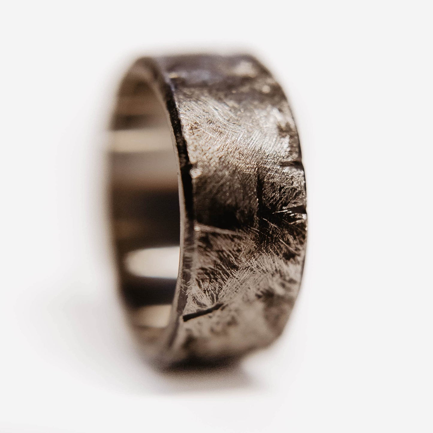 Handmade Tungsten Wedding Band. This photo shows a battle worn, scratched, and gashed 10mm tungsten ring. (Vertical with white background)