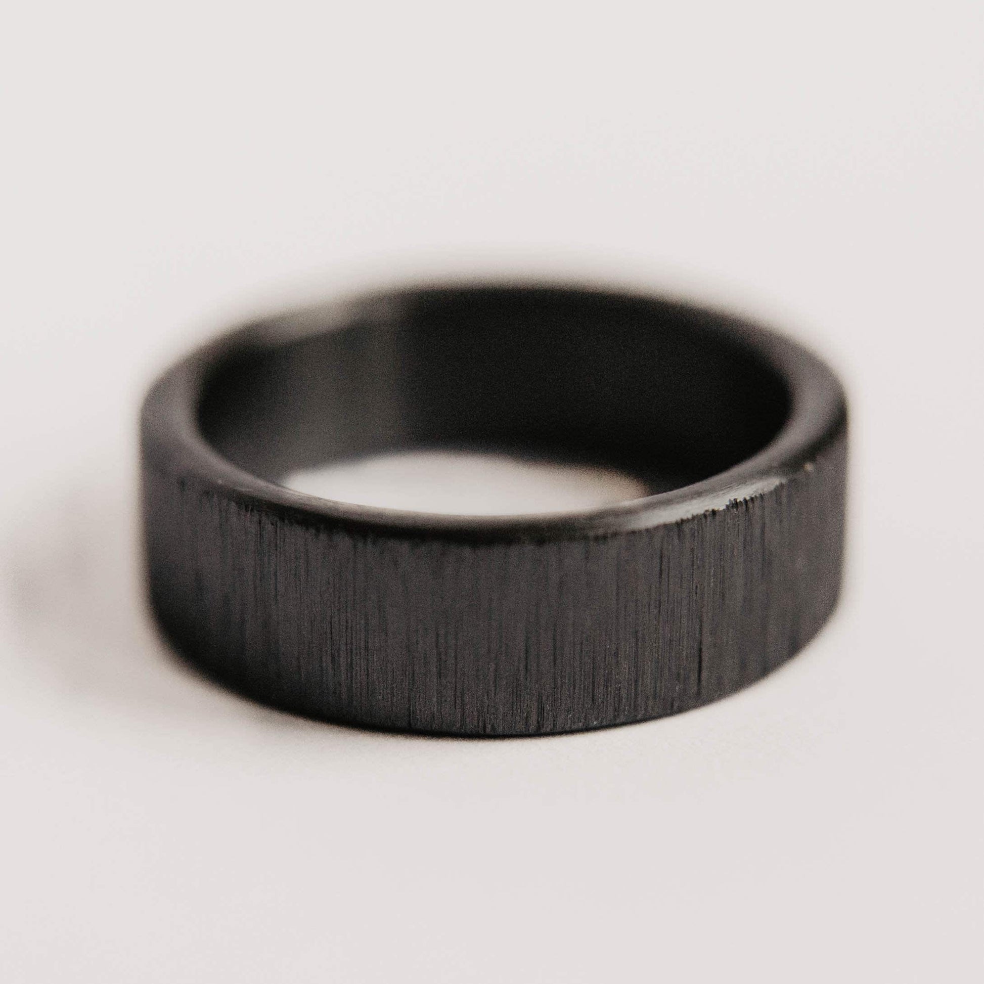 Vertical Grit Zirconium Mens Wedding band. This photo shows a vertical grit zirconium band. (Horizontal with white background)