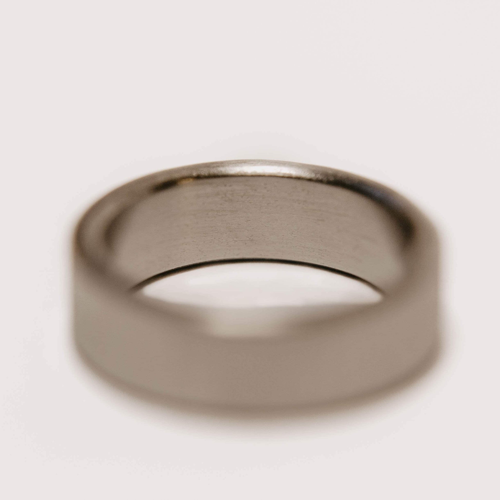 Vertical Grain Titanium wedding band. This photo shows a vertical grain gray titanium ring. (Horizontal with white background)