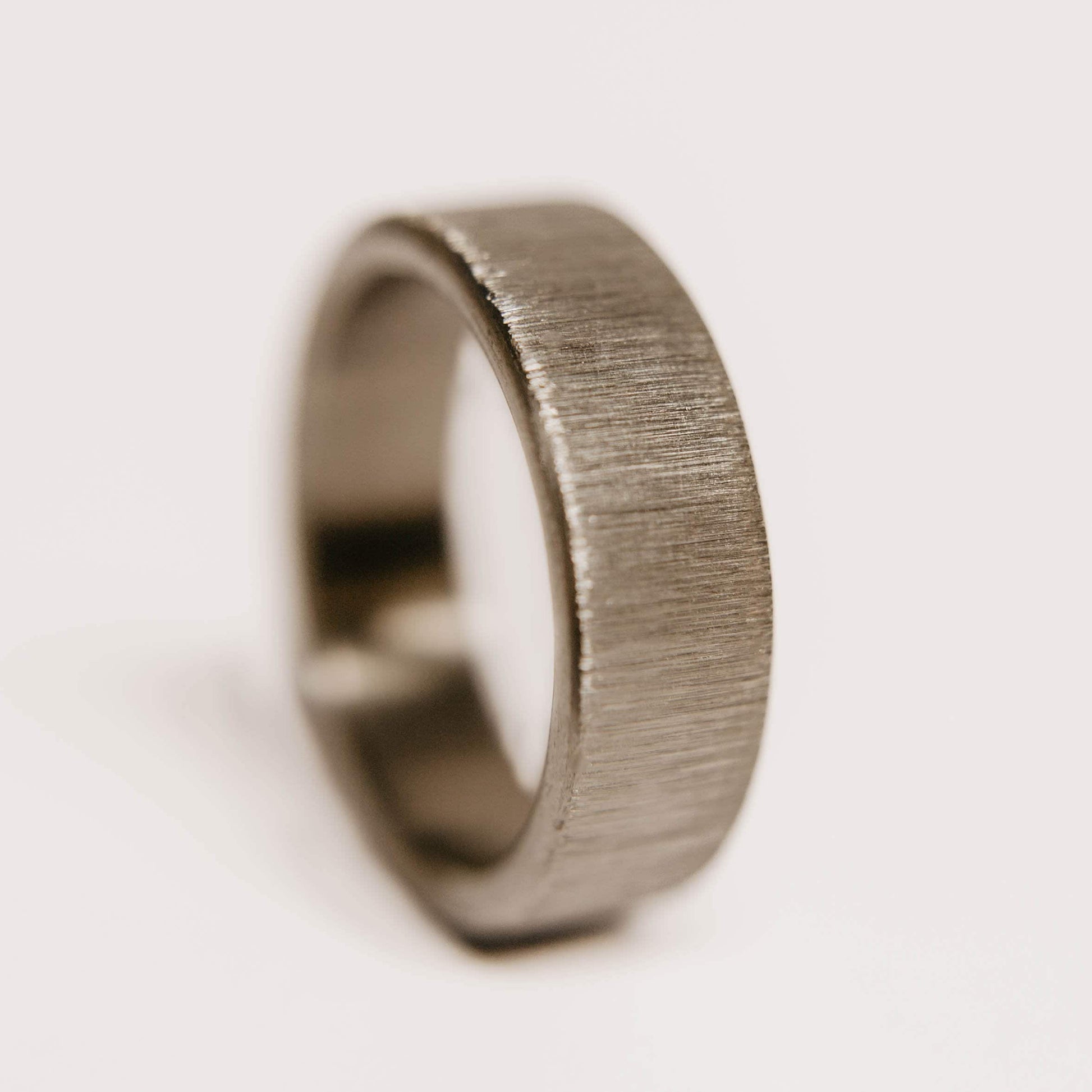 Vertical Grain Titanium wedding band. This photo shows a vertical grain gray titanium ring. (Vertical with white background)