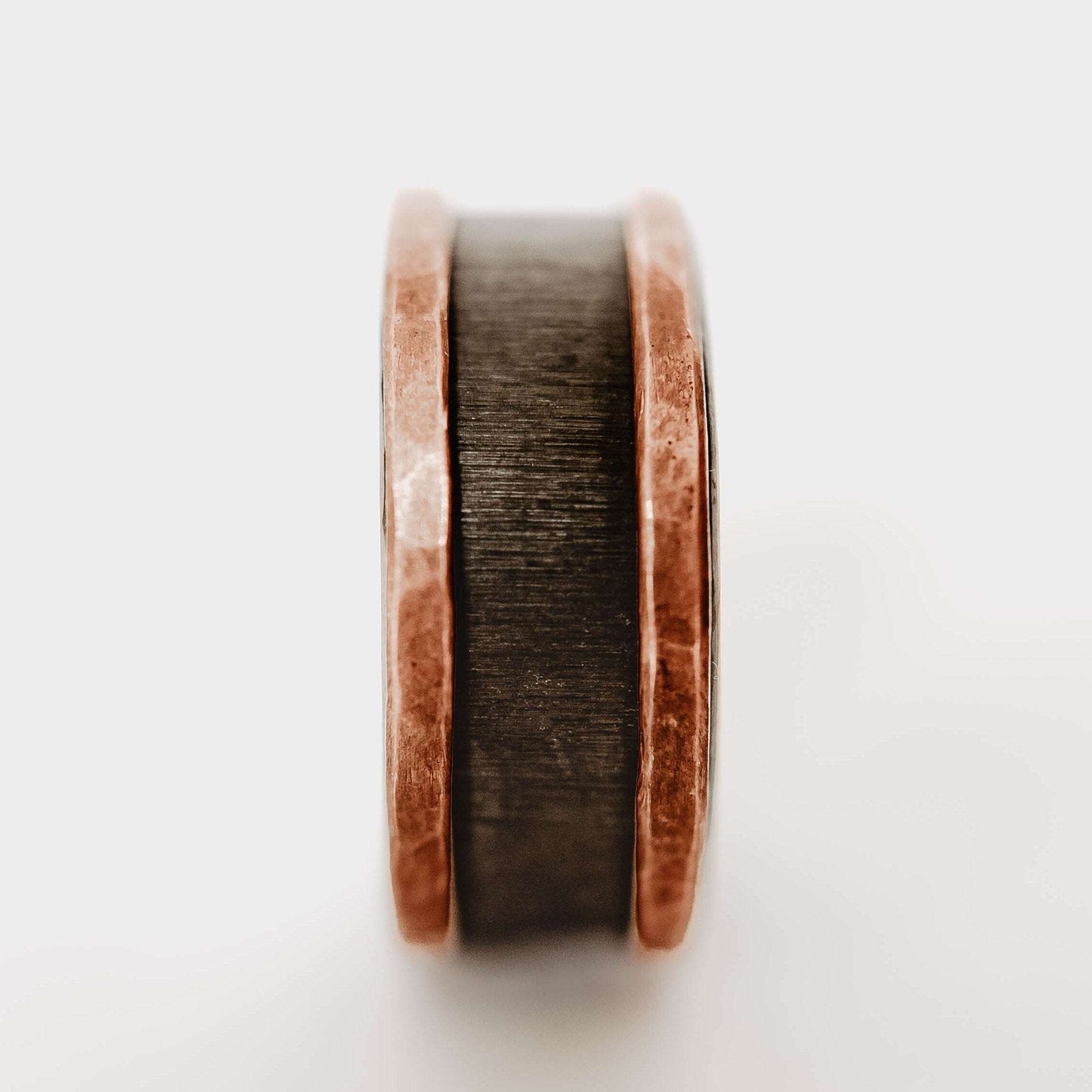 Mens zirconium and copper wedding band. This photo shows a vertical grit zirconium band with a copper band on each edge. (Vertical with white background)