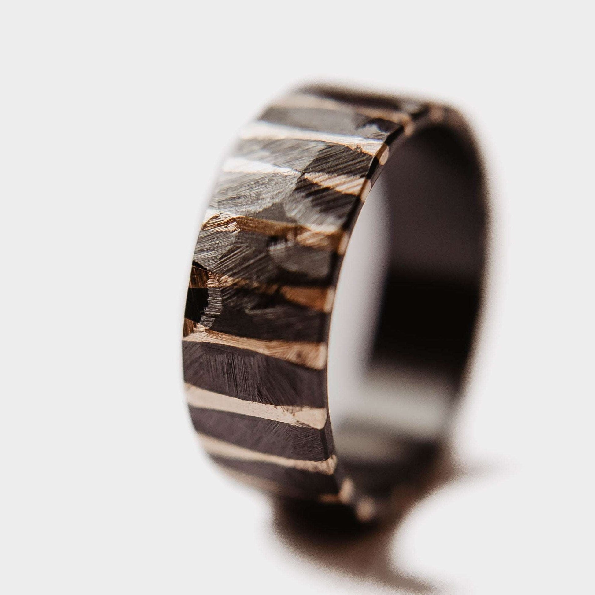 Gold Twilight Wedding Band. This photo shows a roughly faceted zirconium wedding band with 14k gold stripes (Vertical with white background)