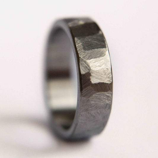 Distressed titanium wedding band. This photo shows a gritty faceted gray titanium ring. (Vertical with white background)