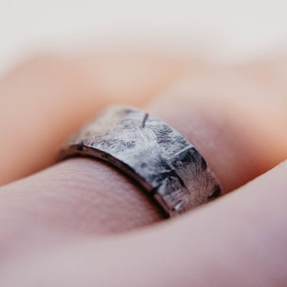Handmade Tungsten Wedding Band. This photo shows a battle worn, scratched, and gashed 10mm tungsten ring. (Shown on finger))