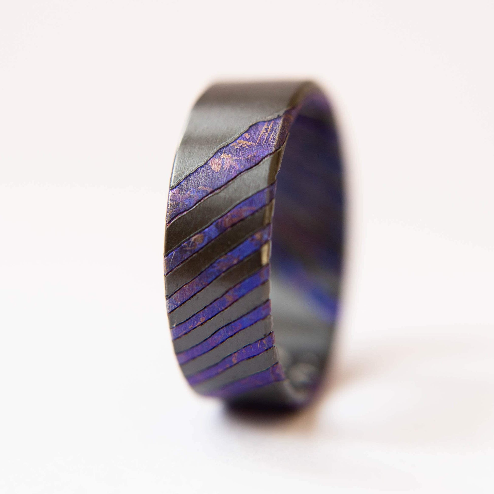 Black Zirconium and Crystallized Titanium Damascus Wedding Band. Black and Violet Ring. (Vertical with white background)
