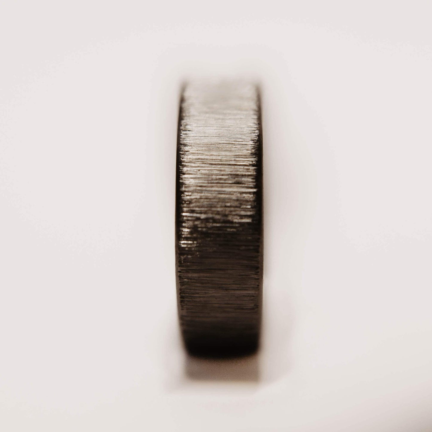 Vertical Grain Titanium wedding band. This photo shows a vertical grain gray titanium ring. (Vertical with white background)