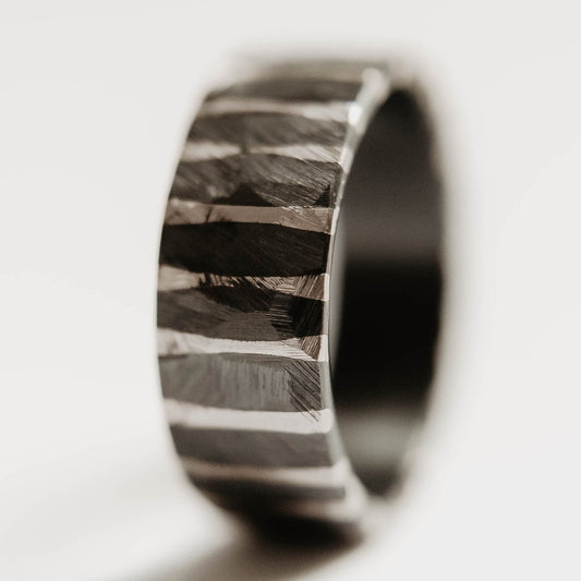 Moonlight Silver Wedding Band. This photo shows a roughly faceted zirconium wedding band with sterling silver stripes (Vertical with white background)