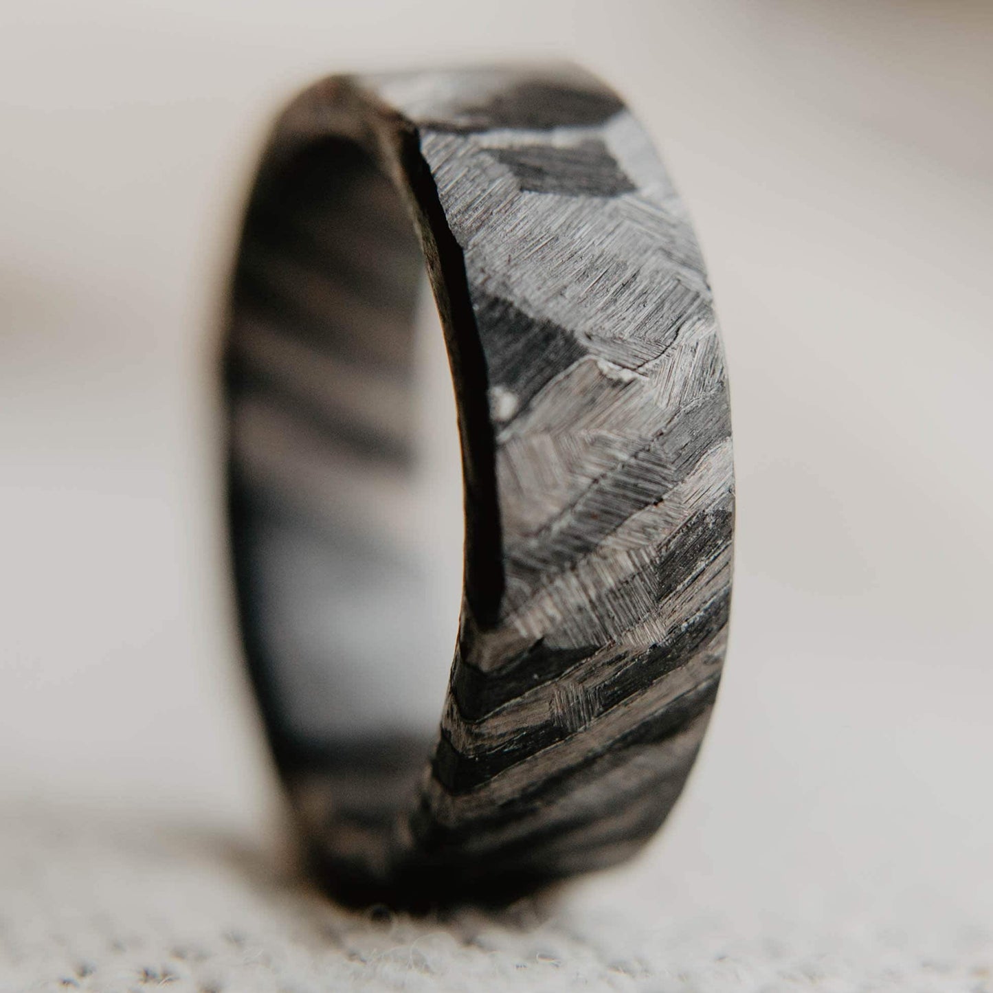 Distressed Black Zirconium and Titanium Damascus Wedding Band. Black and Gray Ring. (Vertical with cloth background)