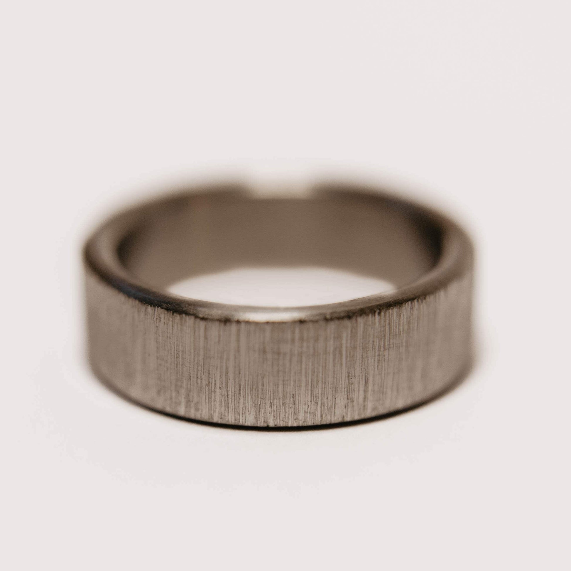 Vertical Grain Titanium wedding band. This photo shows a vertical grain gray titanium ring. (Horizontal with white background)