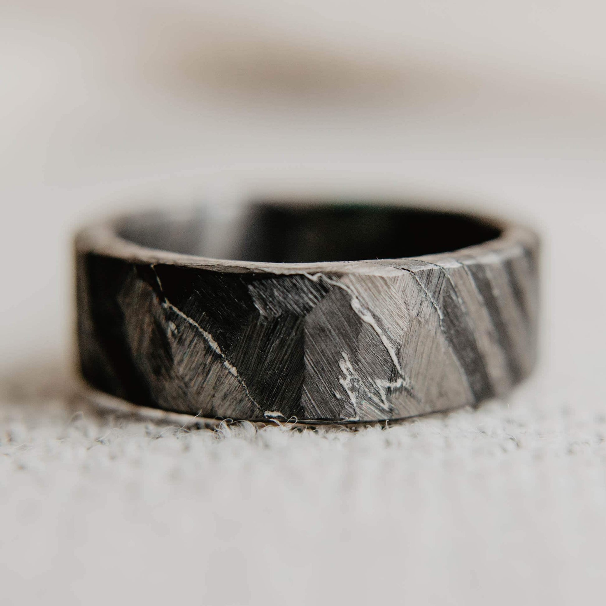Distressed Black Zirconium and Titanium Damascus Wedding Band. Black and Gray Ring. (Horizontal with cloth background)